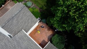 Overhead picture of a Oddly Satisfying Pressure Washing employee cleaning a patio